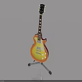 Electric Guitar With Sunburst Finish On Stand Against Gray Background