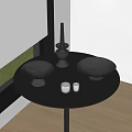 Decorative Ornament Set On Black Round Table With Black Bowls Candleholder And Glass Cups