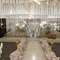 Elegant Banquet Hall Decor With Hanging Chandeliers Floral Arrangements And Gold Accents