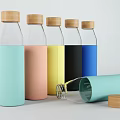 Transparent Glass Bottles With Wooden Lids And Colorful Silicone Sleeves In Various Colors