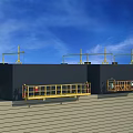 Large Black Industrial Equipment With Yellow Overhead Structures And Guardrail Platforms