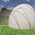White Dome Structure With Golden Arched Supports On Green Grass Under Blue Sky