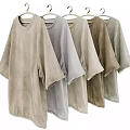 Loose Fit Short Sleeve Casual Tops With Soft Fabric And Neutral Tones Hanging On