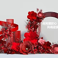 Elegant Red Themed Photo Check In Spot With Floral Arrangements And Ribbon Decorations