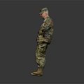 Military Soldier In Camouflage Uniform Standing With Hands On Hips Against Gray Background