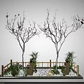 Garden Ornament With Two White Trees Pink Blossoms Green Plants Bamboo Fence And White Pebbles