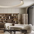 Modern Living Room With Beige Curved Sofa Round Coffee Table Bookshelf Wall And Green Plants