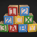 Colorful Wooden Building Blocks with Numbers and Letters Stacked in Pyramid Shape