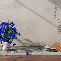 Blue Flowers in Ceramic Vase with Scrolls Tea Set on Wooden Surface and Textured Wall