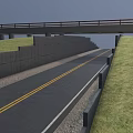 Urban Asphalt Road With Yellow Lines Under Bridge And Concrete Wall Along Green Grass
