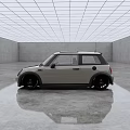 Small Silver Gray Car with Black Roof and Black Wheels in Spacious Modern Indoor Space