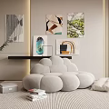 Comfortable Gray Bean Bag Chair With Books Potted Plant And Abstract Wall Art