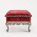 Elegant Red Ottoman With Fringed Trim And Ornate Silver Carved Legs