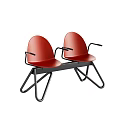 Two Red Public Chairs With Black Armrests And Black Metal Frames
