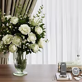 Transparent Glass Vase With White Roses And Green Leaves On Wooden Table