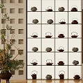 Traditional Tea Pots Display On Multi Layered Shelf With Indoor Plant Decoration
