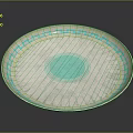 Circular Carved Sculpture Plate with Blue Geometric Patterns and Central Blue Circle on White Surface