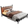 Single Bed Featuring Brown Leather Scalloped Headboard Black Metal Frame Pillows and Patterned Quilt
