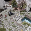 Traditional Chinese Village Courtyard with White Walls Gray Tiles Stone-paved Path and Trees