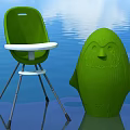 Green Children's Chair With Penguin Shaped Figure On Blue Water Background