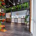 Modern Restaurant Interior With Brick Partition Wooden Table Metal Chairs And Green Plants