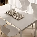 Modern White Dining Table Set With Silver Trays Glassware White Chairs And Wooden Flooring 3d model