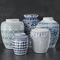 Lush Green Plants Displayed in Blue and White Patterned Vases on Dark Background