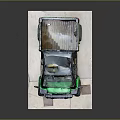Green And Black Utility Vehicle With Cargo Bed Yellow Wheels On White Platform