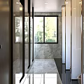 Modern Public Toilet with Glass Doors Windows Marble Walls and Tiled Floor