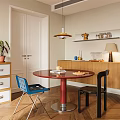 Dining Room With Red Round Table Blue Black Chairs Wooden Cabinets And Yellow Pendant Light