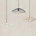 Three Modern Unique Design Pendant Lights Hanging On Light Colored Wall Interior