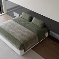 Modern Double Bed With White Paneled Headboard Green Quilt Gray Blanket And Wooden Floor