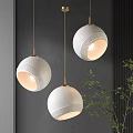 Modern Textured White Spherical Pendant Lights With Golden Chains And Green Plants On Dark Wall