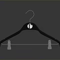 Black Clothes Hanger With Round Logo And White Clips As Household Item