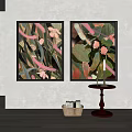 Two Framed Decorative Paintings With Pink Flowers Green Leaves And Small Table With Candles