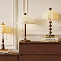 Stylish Table Lamps On Wooden Cabinet With Decorative Books And Green Plant