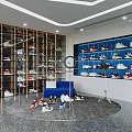 Modern Shoe Store Interior With Display Shelves Blue Sofa And Various Shoes