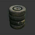 Stack of Used Car Tires with Metal Rims and Worn Tread Surface