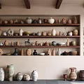 Ceramic Vessels Displayed On Wooden Shelves With Various Shapes And Earthy Tones