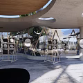 Modern Circular Building with Glass and Wooden Structure on Lawn by Blue Sky and Sea