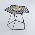 Modern Coffee Table With Black Metal Frame And Striped Top Featuring Two Lemons