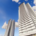 Modern High Rise Residential Buildings With Glass Curtain Walls And Landscaped Ground