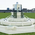 Elegant Multi Tiered Water Fountain With White Stone Base And Flowing Water On Green Lawn