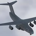 Gray Passenger Airplane Flying With Extended Wings In Overcast Sky