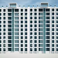 Modern High Rise Apartment Building With White Exterior And Blue Glass Windows