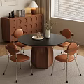 Modern Restaurant Interior Featuring Round Black Table Orange Chairs and White Vase