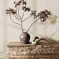 Rustic Clay Pot Vase with Branches and Brown Leaves on Wooden Tabletop Light Background Shadows