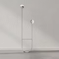 Modern Minimalist Floor Lamp With Sleek Metal Frame And Glass Base Against Neutral Wall