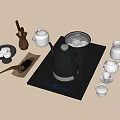 Stylish Tea Set Featuring Black Teapot Electronic Heating Tray Ceramic Teacups and Tea Leaves
