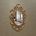 Ornate Gold Framed Oval Mirror Hanging On Gray Wall Reflecting Living Room Scene